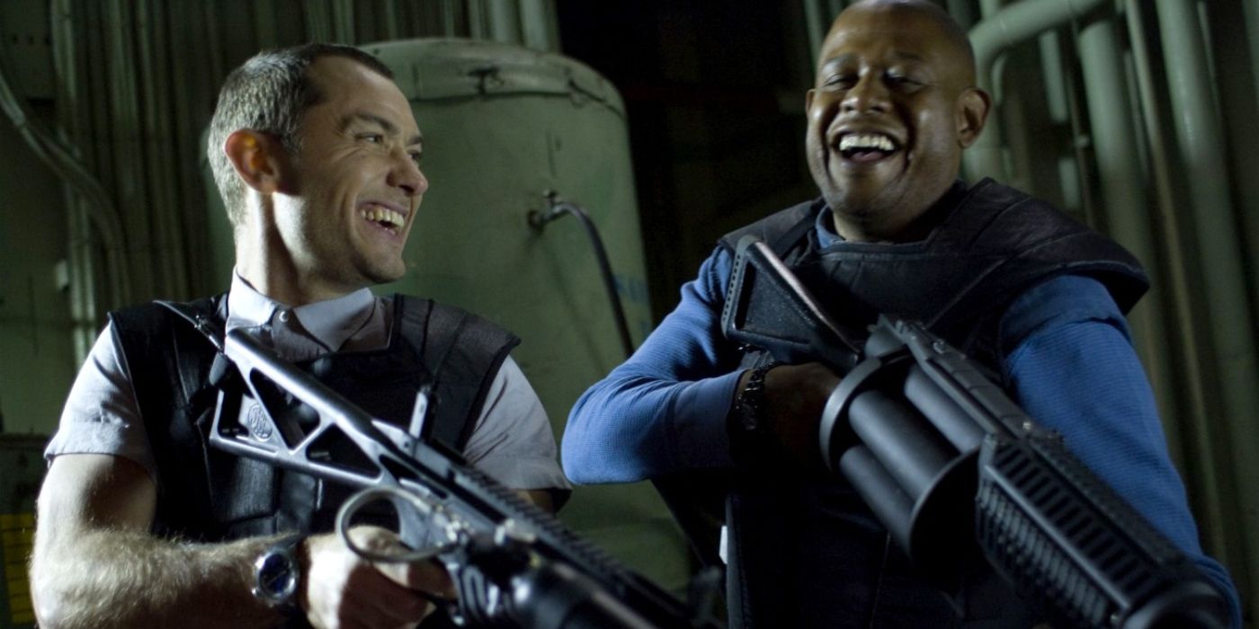Remy (Jude Law) and Jake (Forest Whitaker) laugh while holding guns in &lsquo;Repo Men&rsquo;