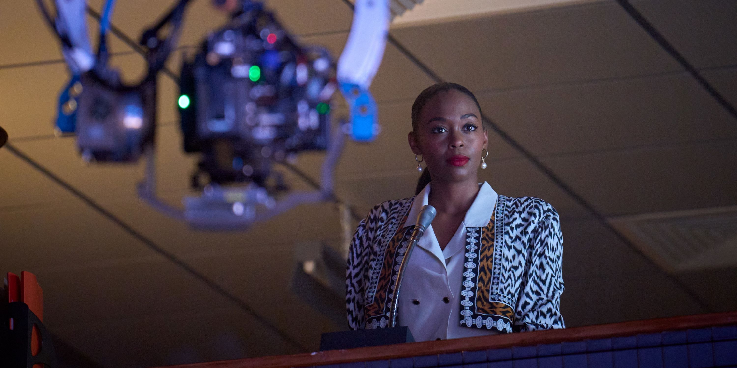 Nafessa Williams as Cameron Cook in the producer's booth above the TV studio in Rivals
