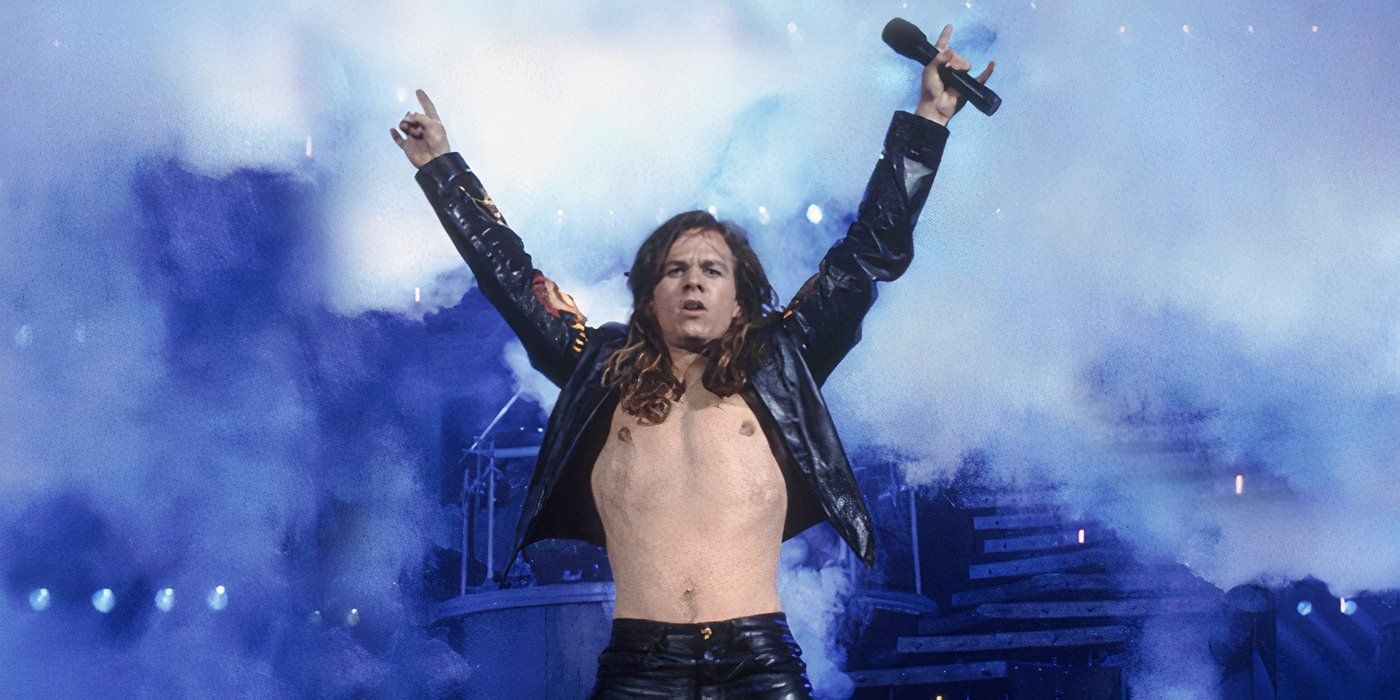 Izzy (Mark Wahlberg) holding up 'rock on' signs while performing in 'Rock Star' (2001)