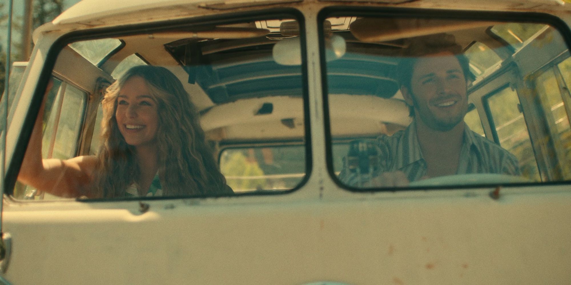 Jessica Rothe as Sarah and Callum Kerr as Everett sit in a vintage vehicle together and smile in Virgin River