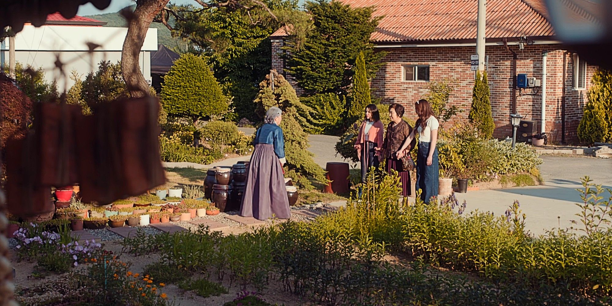 Kitty and Margo holding hands with their grandmother as they reunite her with her sister in the Season 2 finale of XO, Kitty