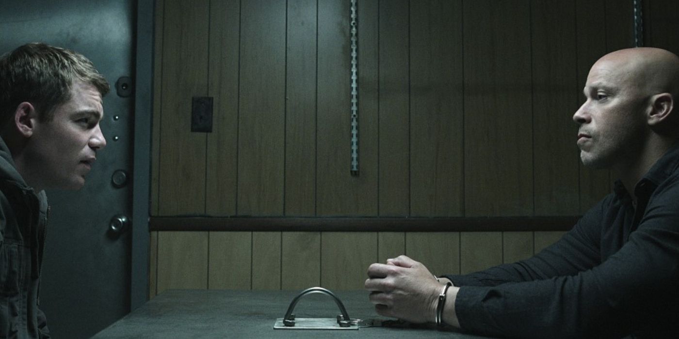 Gabriel Basso as Peter sitting across from Berto Colon as Solomon in Season 2 of 'The Night Agent'