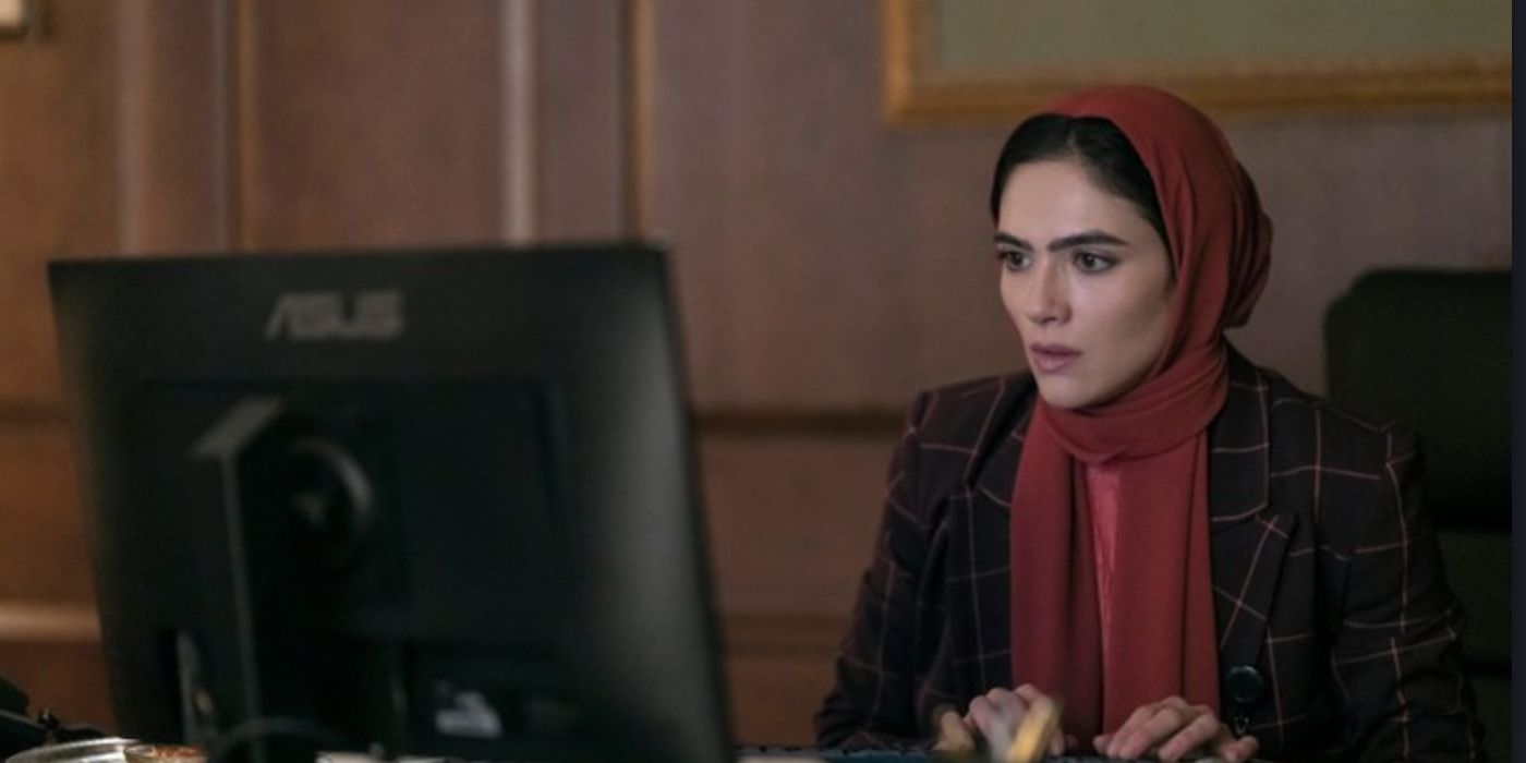 Arienne Mandi as Noor typing on a computer in 'The Night Agent'