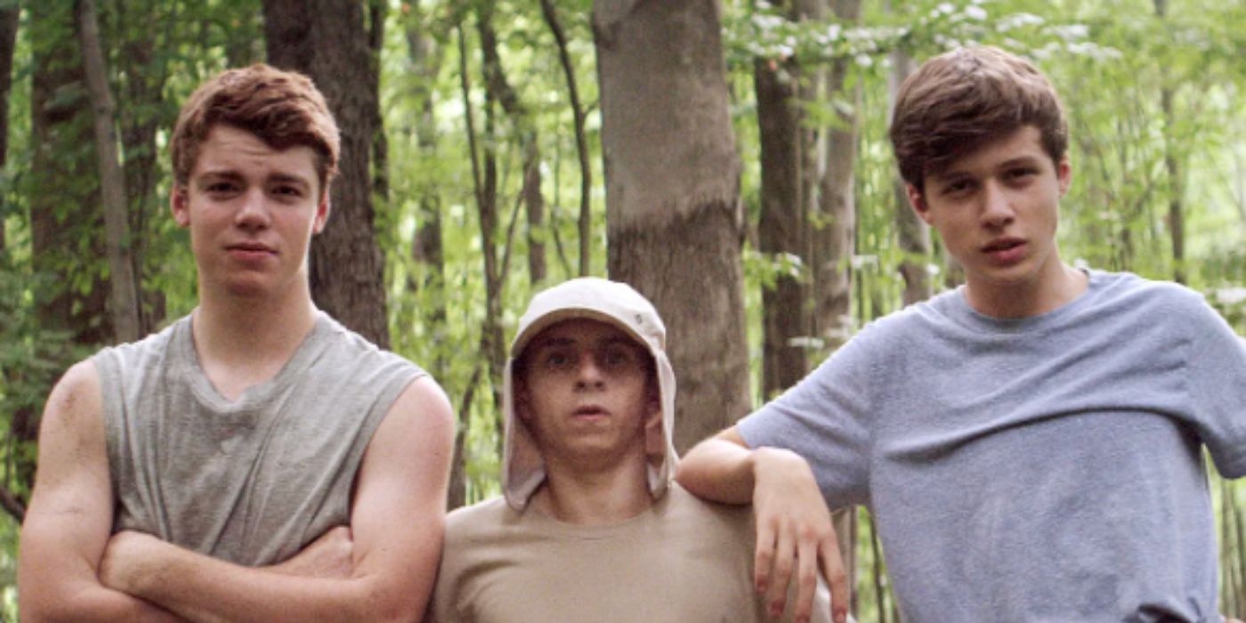 Gabriel Basso, Moises Arias, Nick Robinson as Patrick, Biaggo, and Joe staring at the camera standing against the trees in 'The Kings of Summer'