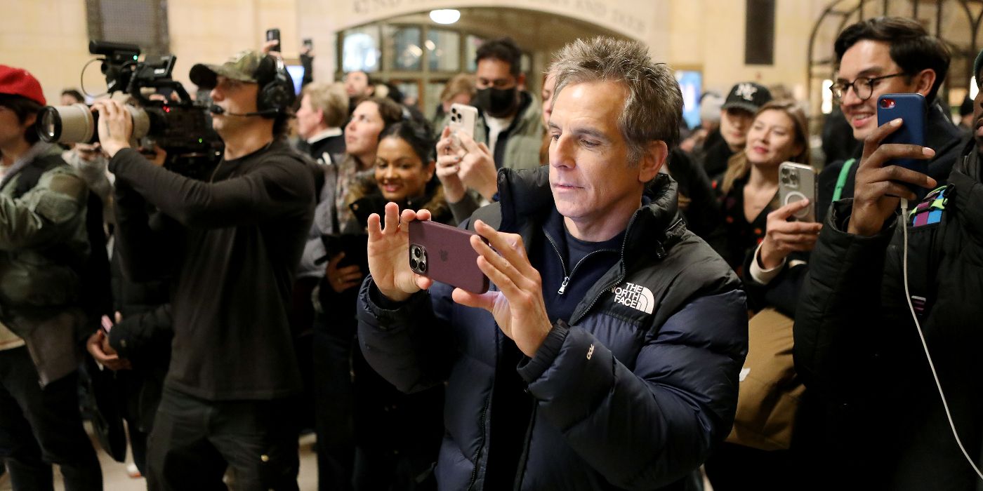 Severance director Ben Stiller taking pictures of the pop-up event in Grand Central