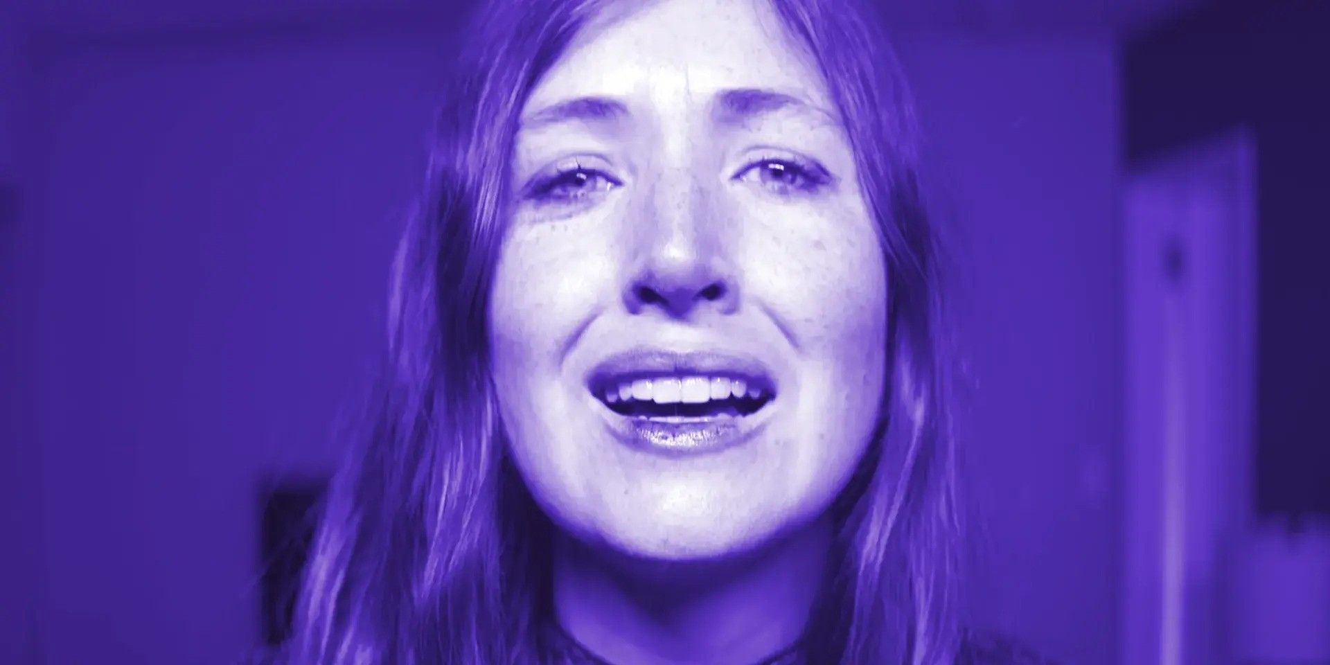 Kate Lyn Sheil as Amy engrossed in a bright purple light as she looks into the face of death itself in &lsquo;She Dies Tomorrow&rsquo; (2020)