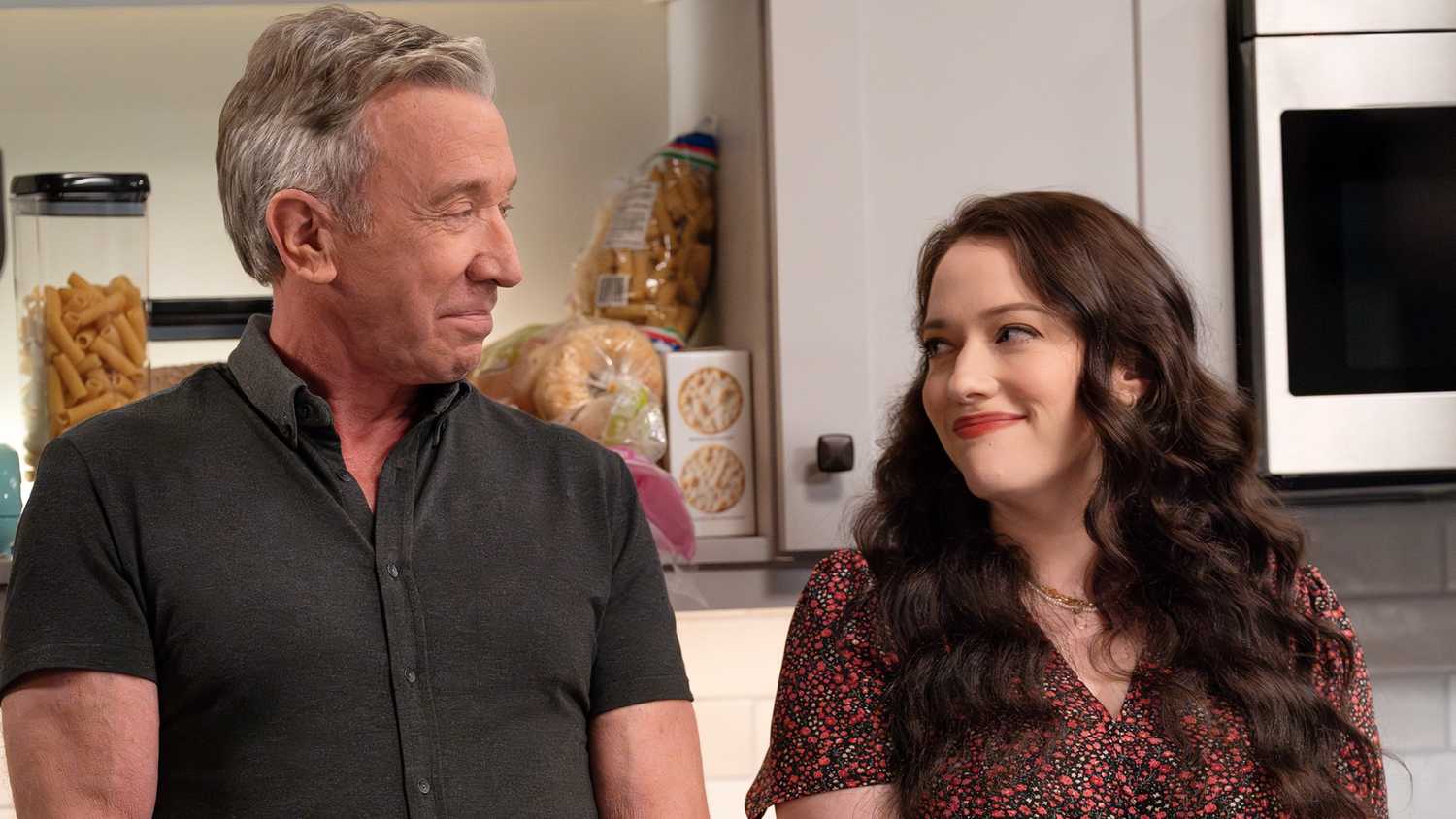 Tim Allen as Matt standing next to and looking at Kat Dennings as Riley in the kitchen in Shifting Gears.