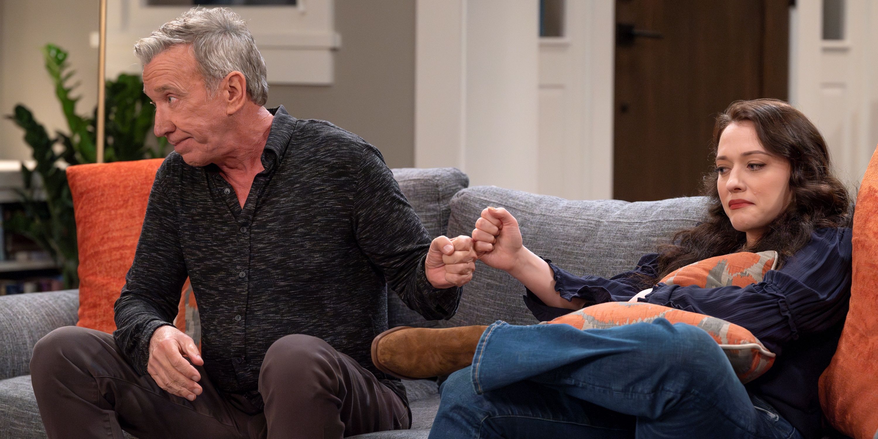 Tim Allen as Matt fist-bumping Kat Dennings as Riley on the living room couch in Shifting Gears