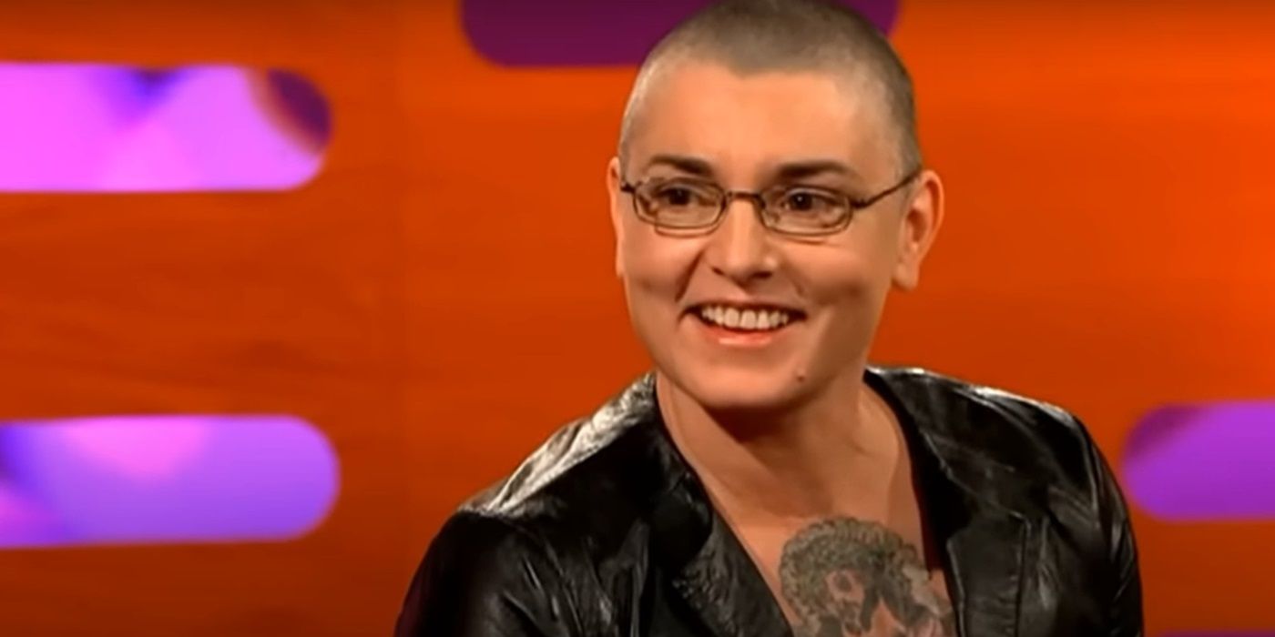 Sinead O'Connor smiling while sitting on the couch on 'The Graham Norton Show'.