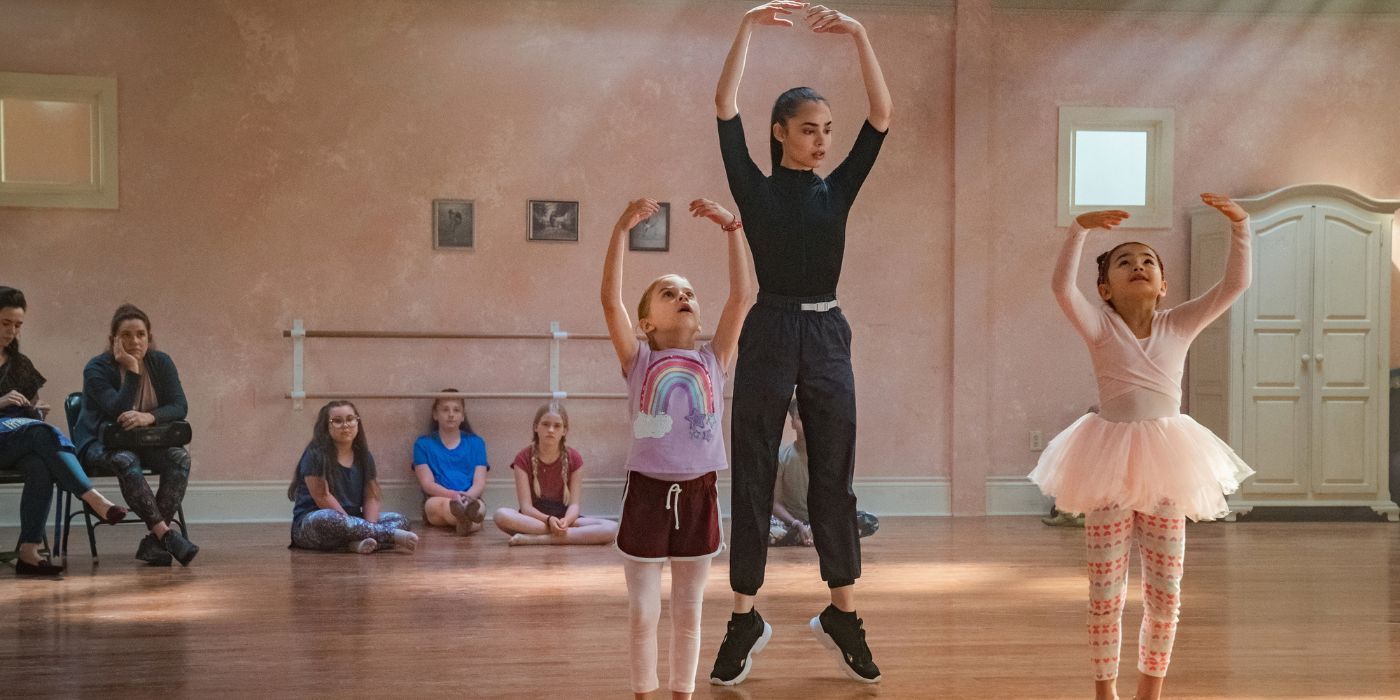 Sofia Carson as April teaching two young girls ballet in Feel the Beat.