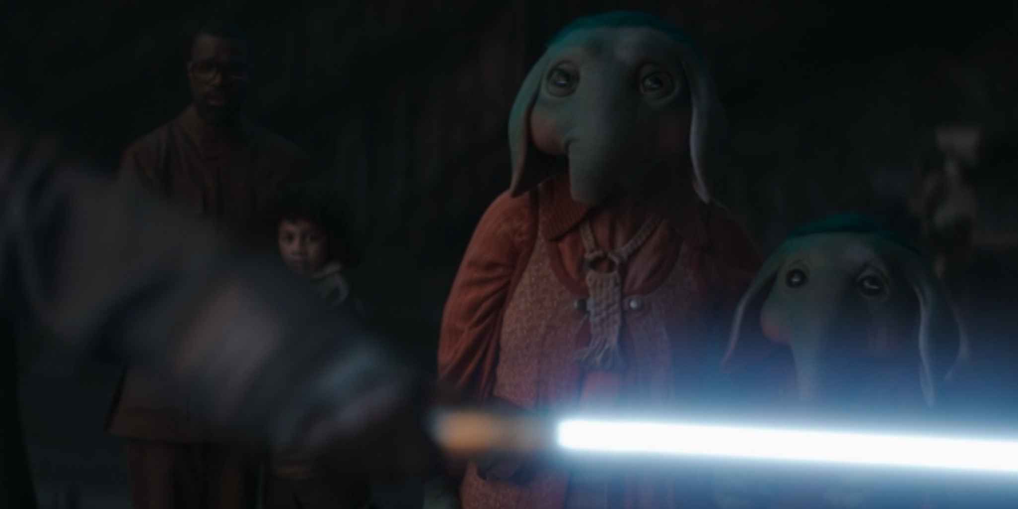 Wendle, Wim, Nooma, and Neel stand in front of Jod and his ignited lightsaber in Star Wars: Skeleton Crew