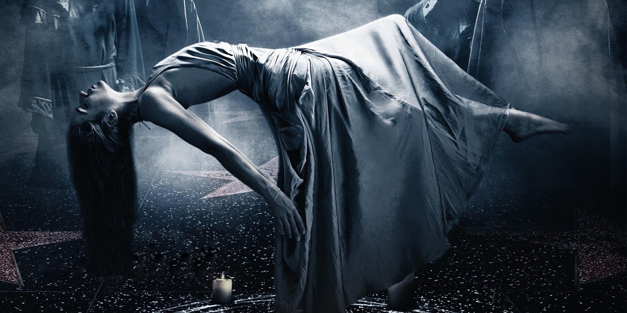 Sarah, played by actor Alexandra Essoe, levitates above a walk of fame while wearing a white dress on the poster for Starry Eyes.