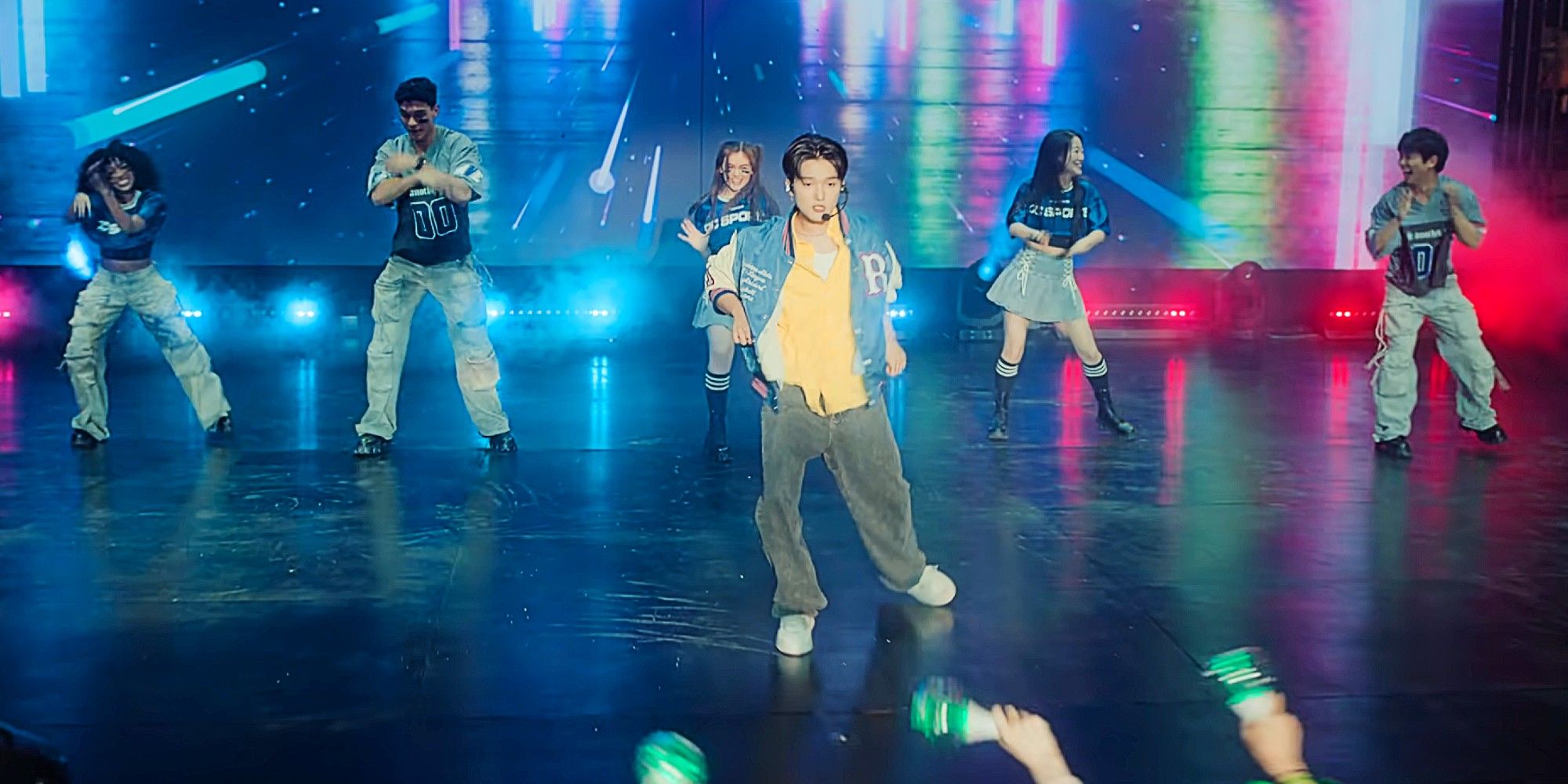 Dae standing in the center of the stage, with his friends behind him in matching outfits -- Juliana, Q, Kitty, Yuri, and Jin -- in the Season 2 finale of XO, Kitty