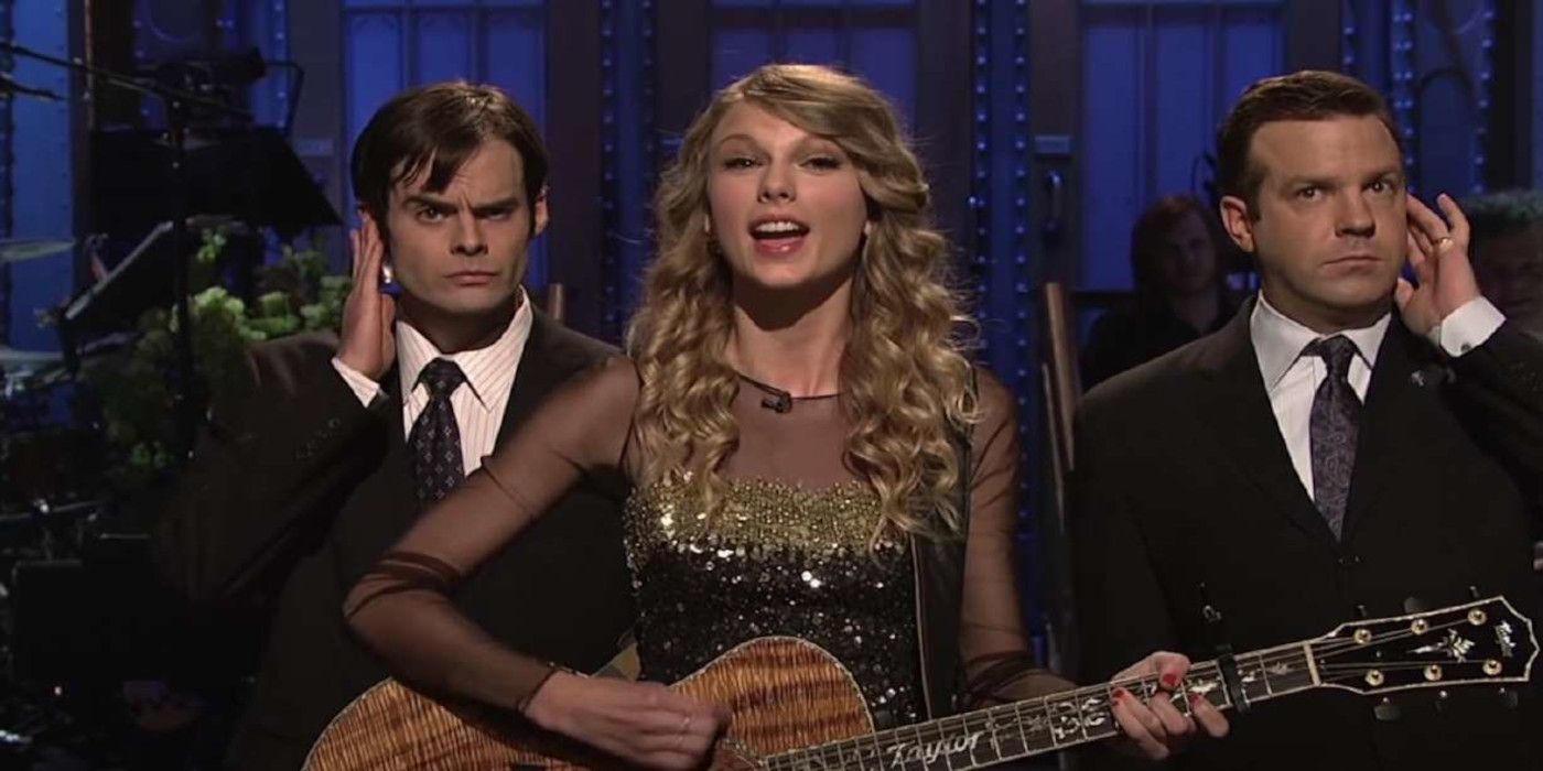 Taylor Swift sings with Bill Hader and Jason Sudeikis on either side as bodyguards on Saturday Night Live.