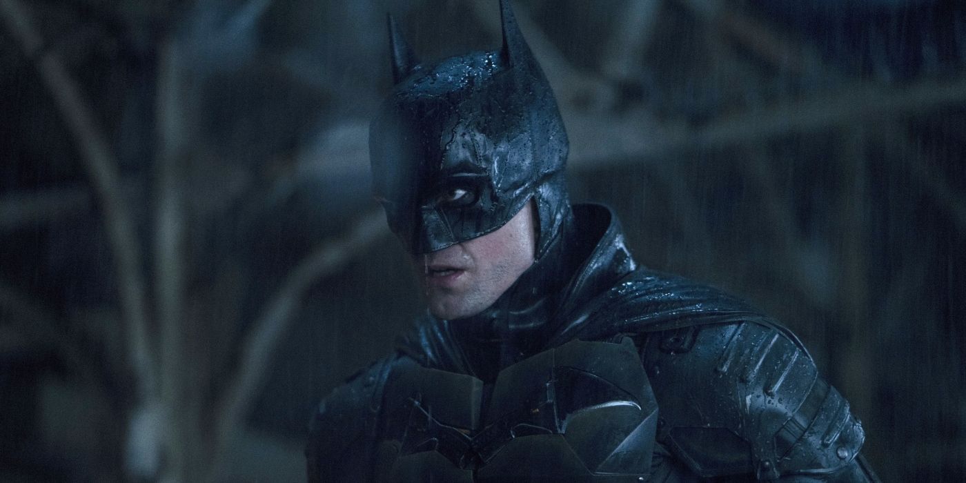 Robert Pattinson as Batman stares intently at something off-screen in The Batman.