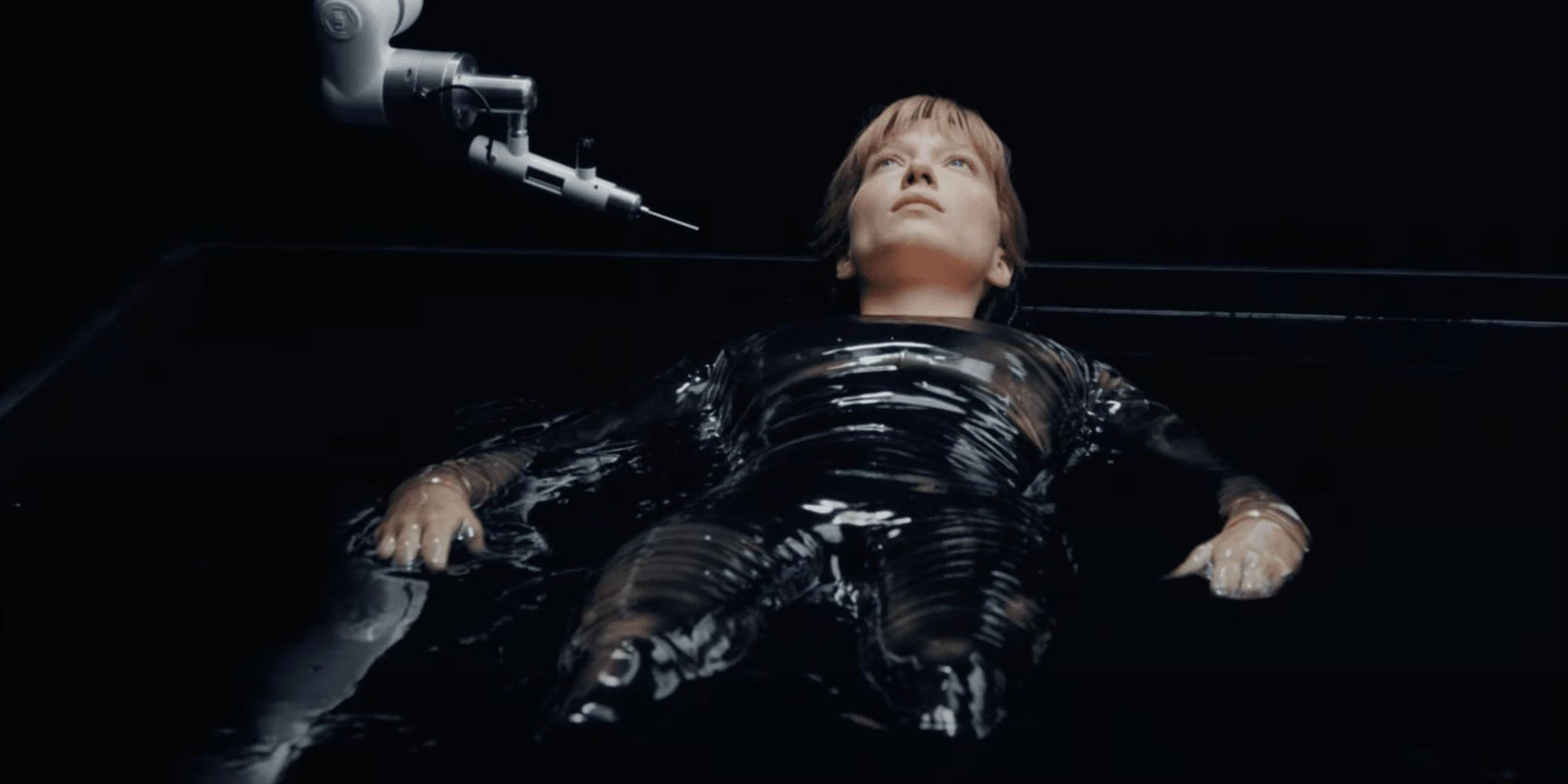Lea Seydoux&rsquo;s character in &lsquo;The Beast&rsquo; sits in a black tank and prepares to undergo a futuristic procedure.