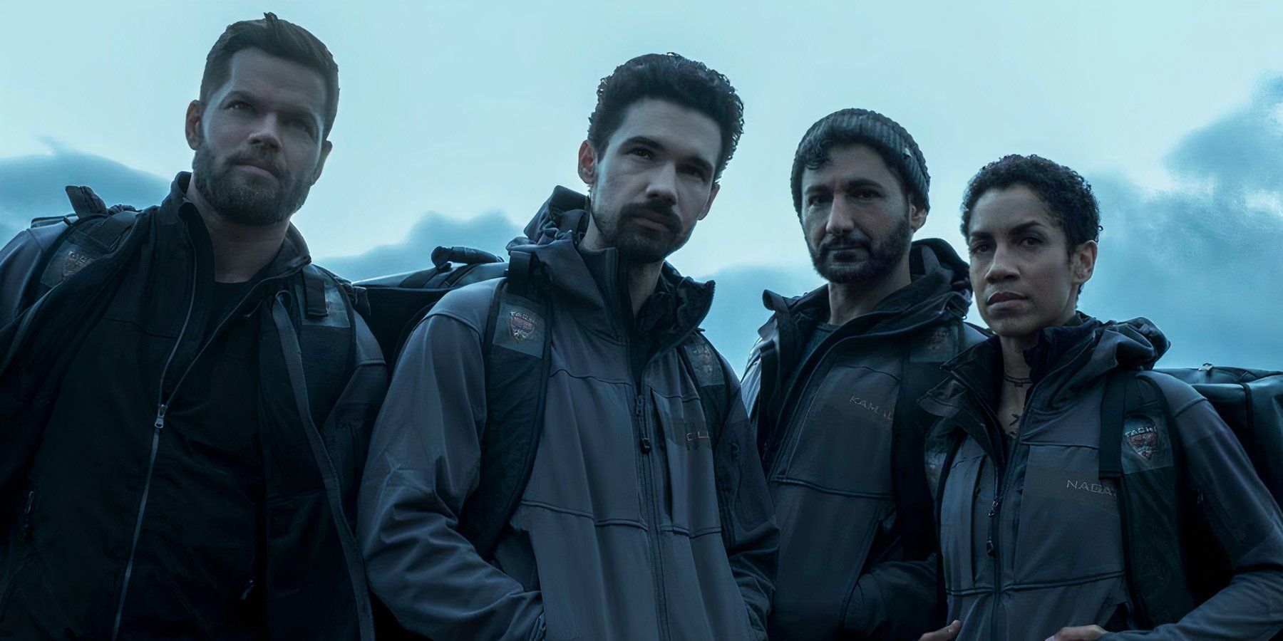 The cast stands outside wearing backpacks and staring off into the distance in The Expanse.