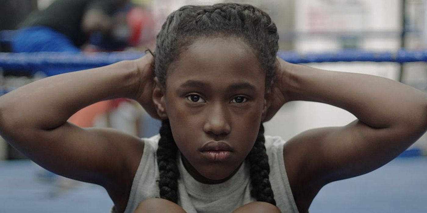 Toni (Royalty Hightower) facing the camera with her hands on her head in The Fits.