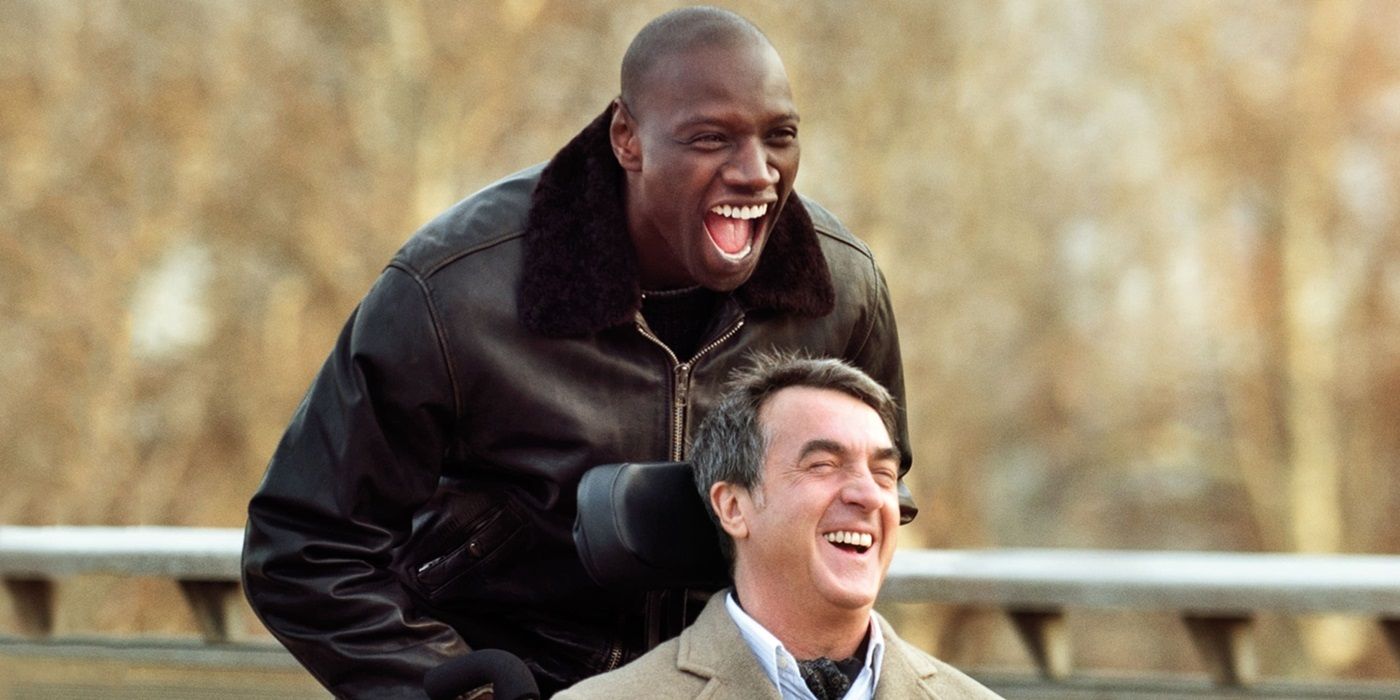 Omar Sy as Driss pushing Fran?ois Cluzet as Philipp's wheelchair in The Intouchables