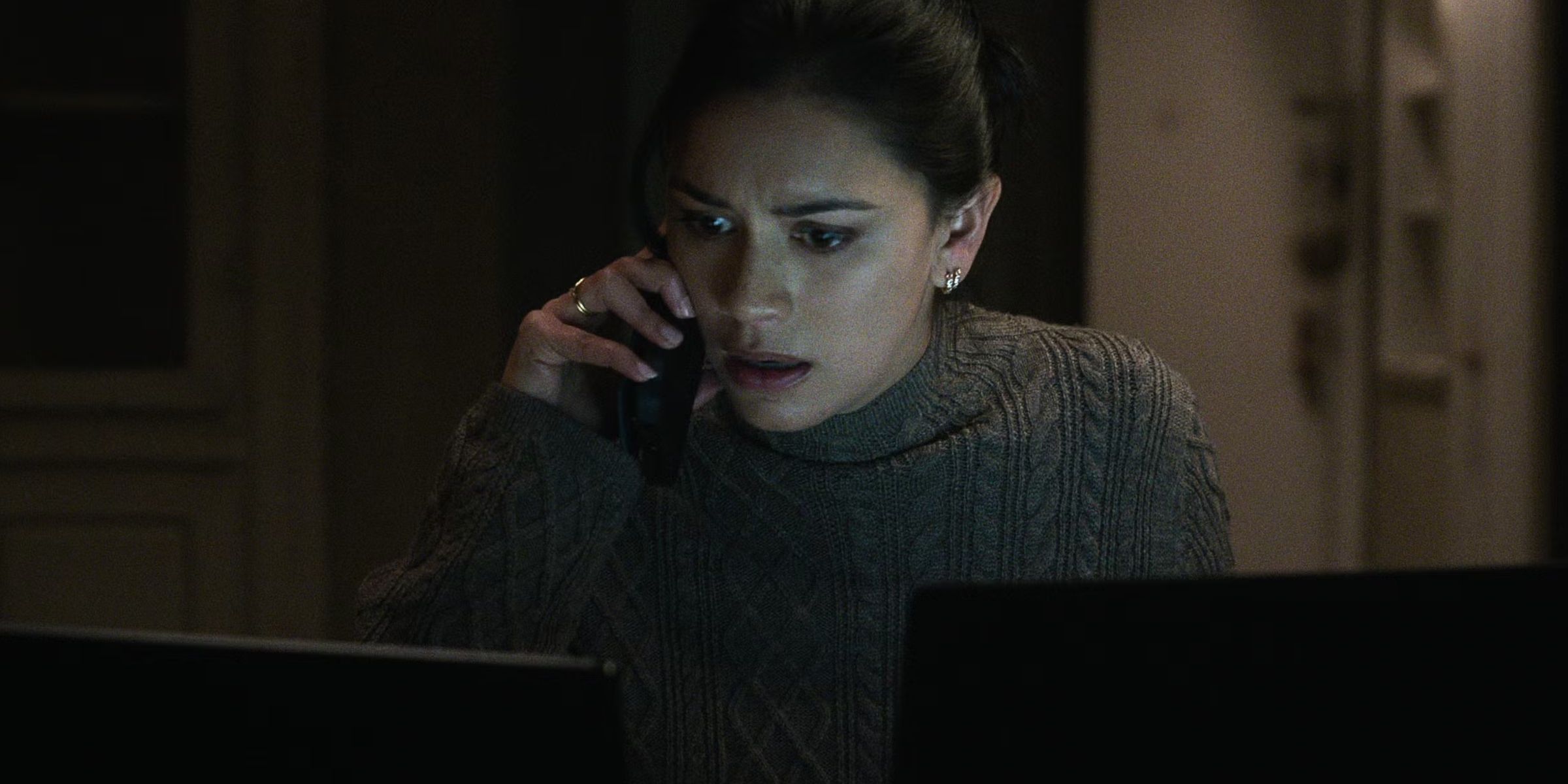 Rose Larkin (Luciane Buchanan) on the phone as she looks at a computer in The Night Agent