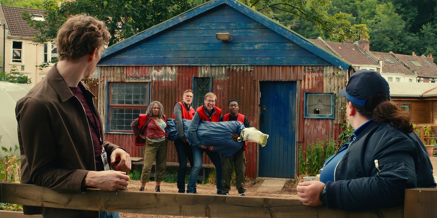 Myrna (Clare Perkins), John (Darren Boyd), Greg (Stephen Merchant), and Christian/Ben (Gamba Cole) get caught smuggling a dead body in &lsquo;The Outlaws&rsquo; (2021).