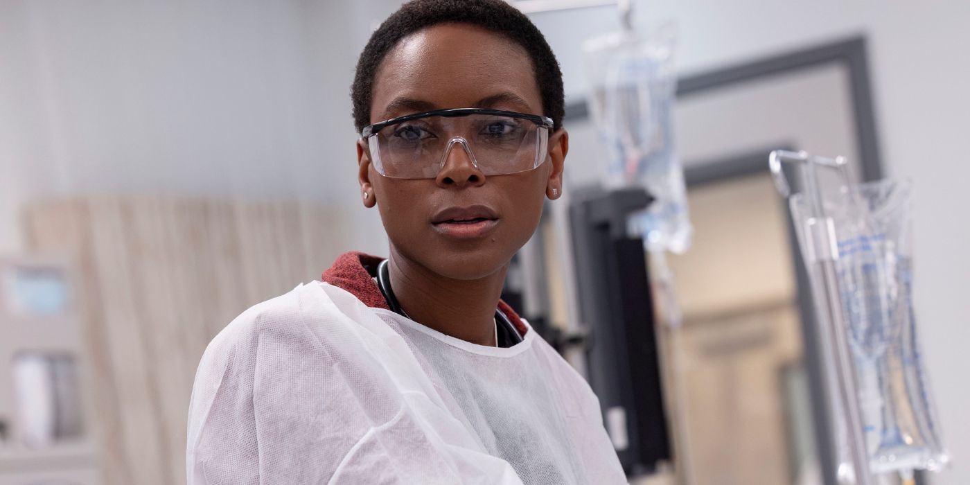 Dr. Collins (Tracy Ifeachor) wearing protective glasses and looking offscreen in The Pitt