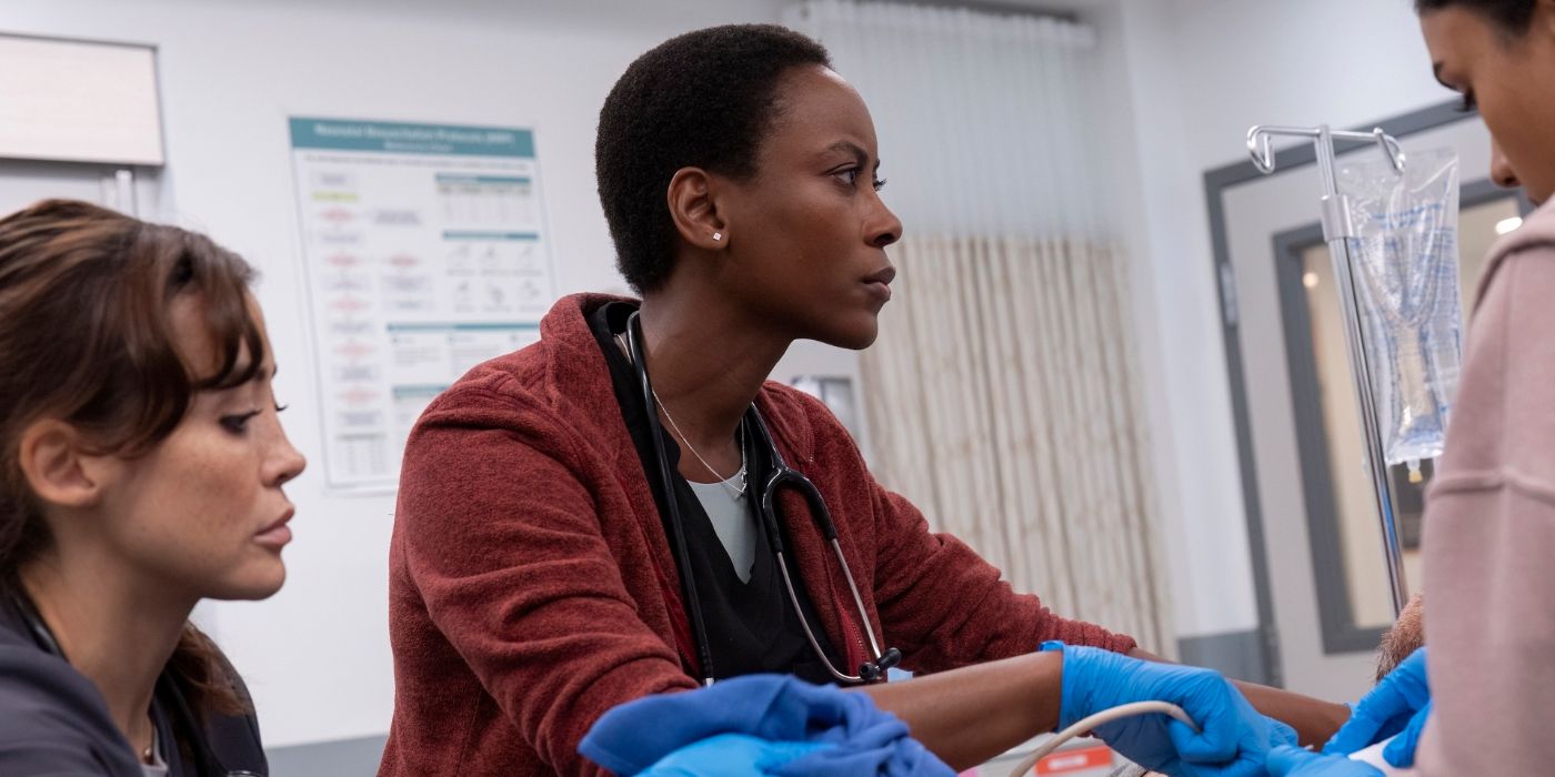 Dr. Collins (Tracy Ifeachor) looking offscreen at a patient&rsquo;s stats as they lie on a gurney in The Pitt