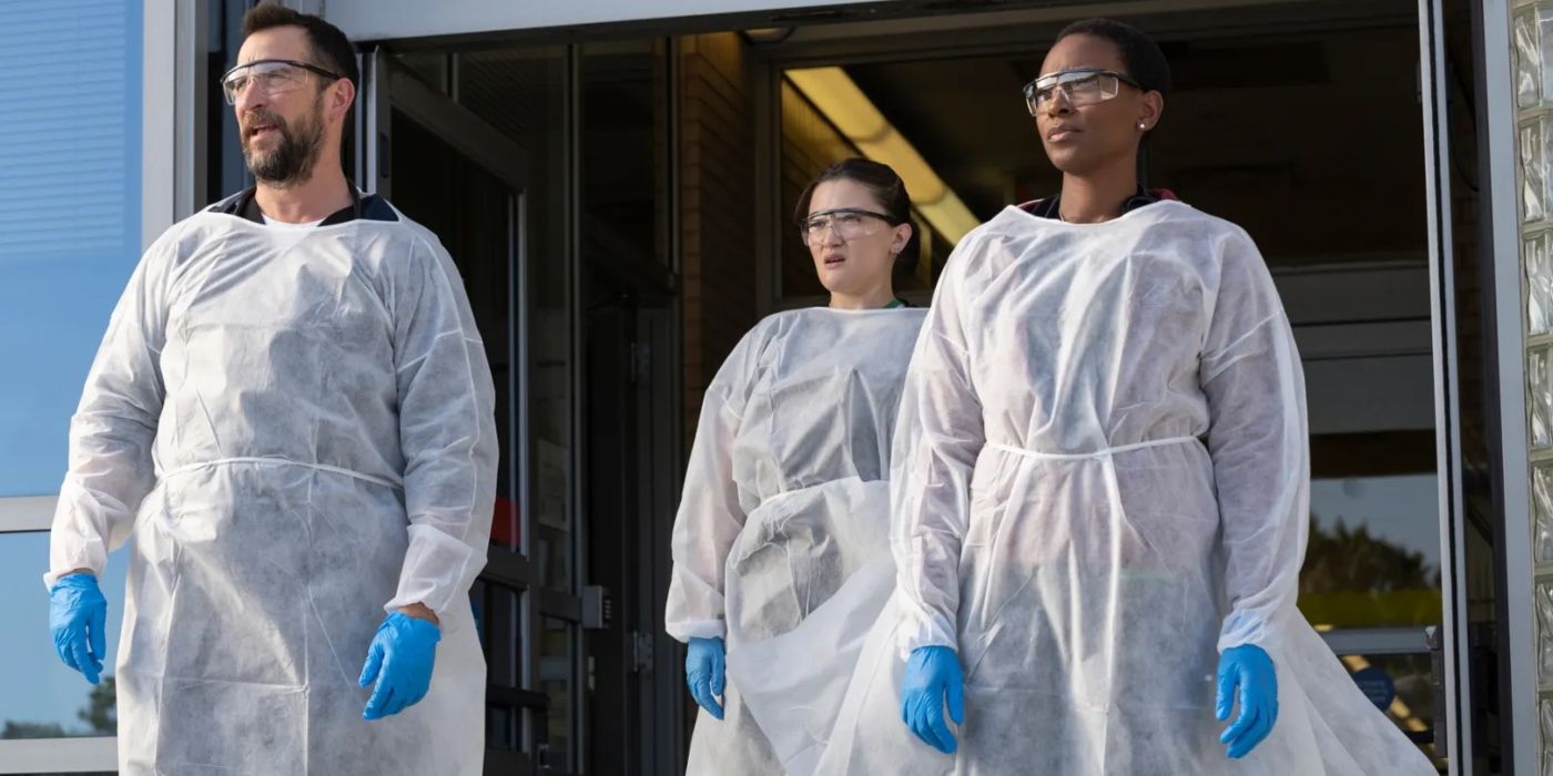 Noah Wyle, Isa Briones, and Tracy Ifeachor stand in white protective gear, gloves, and goggles in 'The Pitt'