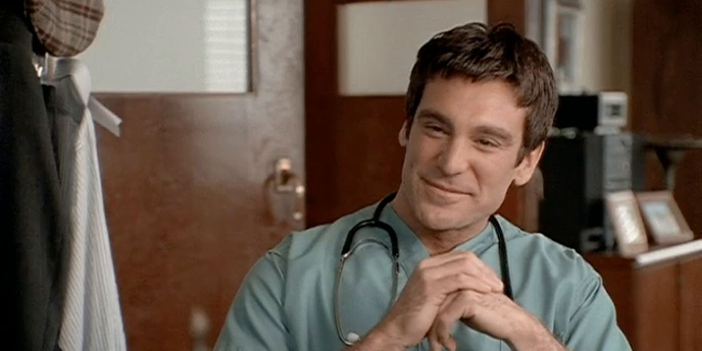 A man dressed as a doctor smiling in The Pretender