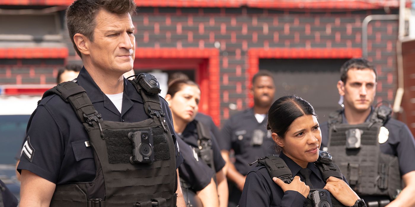 Nathan Fillion as John Nolan and Lisseth Chavez as Celina Juarez standing next to each other in uniform in The Rookie