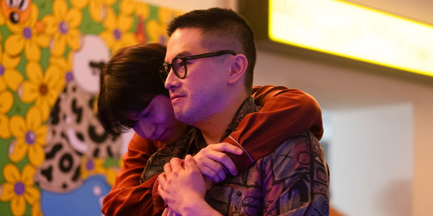A man with his arms wrapped around Bowen Yang&rsquo;s shoulders in The Wedding Banquet