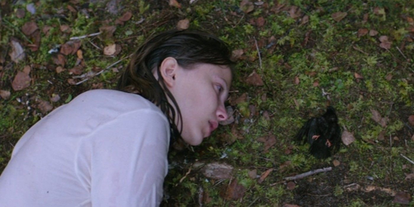 Eili Harboe lies on the ground soaking wet next to a dead bird in &lsquo;Thelma&rsquo; (2017)