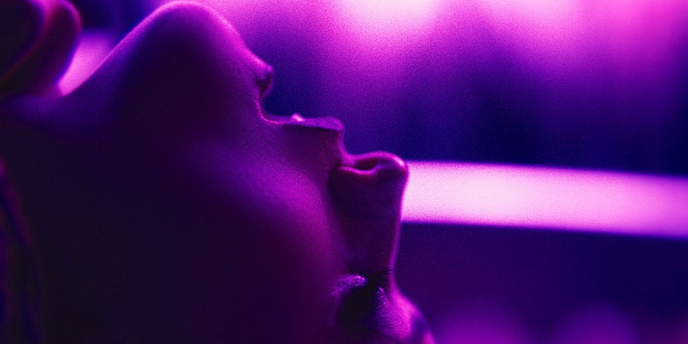 A close-up of Olivia Taylor Dudley upside down in purple lighting in Touch Me