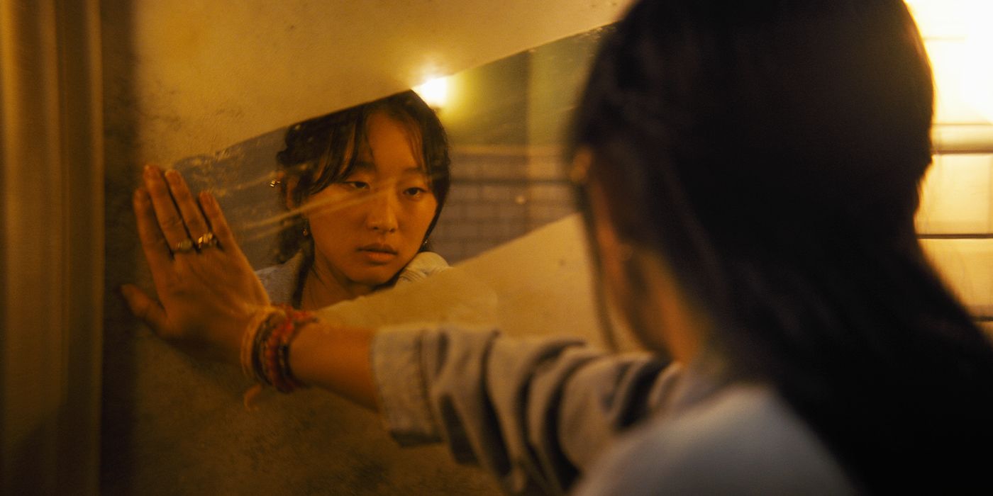 Megan (Ji-young Yoo) wiping steam from a mirror in Until Dawn