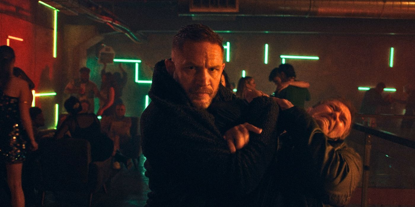 Tom Hardy holding a man at gunpoint in Havoc