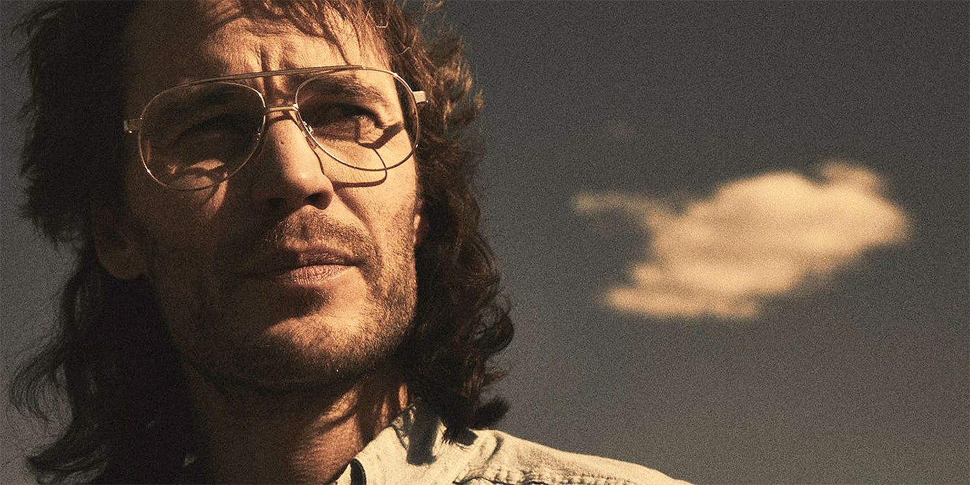 A close up of Taylor Kitsch as David Koresh looking off into the distance in Waco 