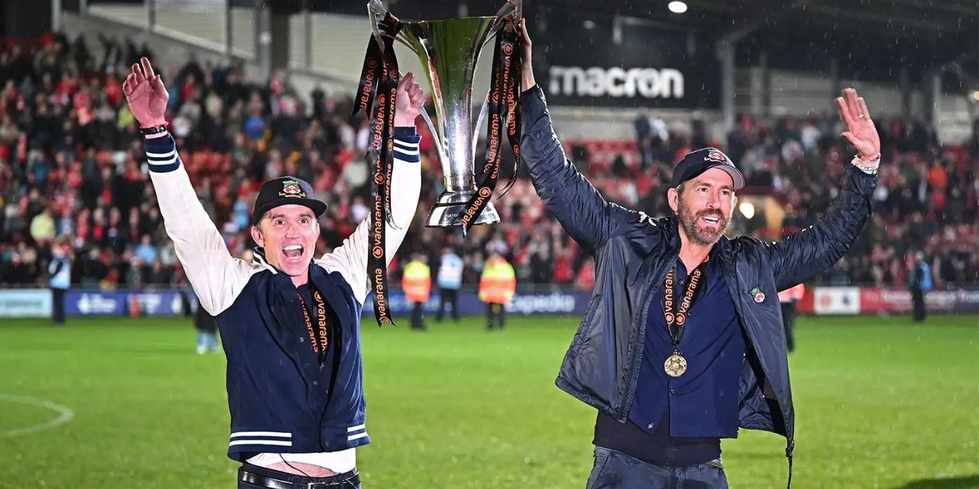 Rob McEllenney and Ryan Reynolds hoist up the trophy on 'Welcome to Wrexham.'