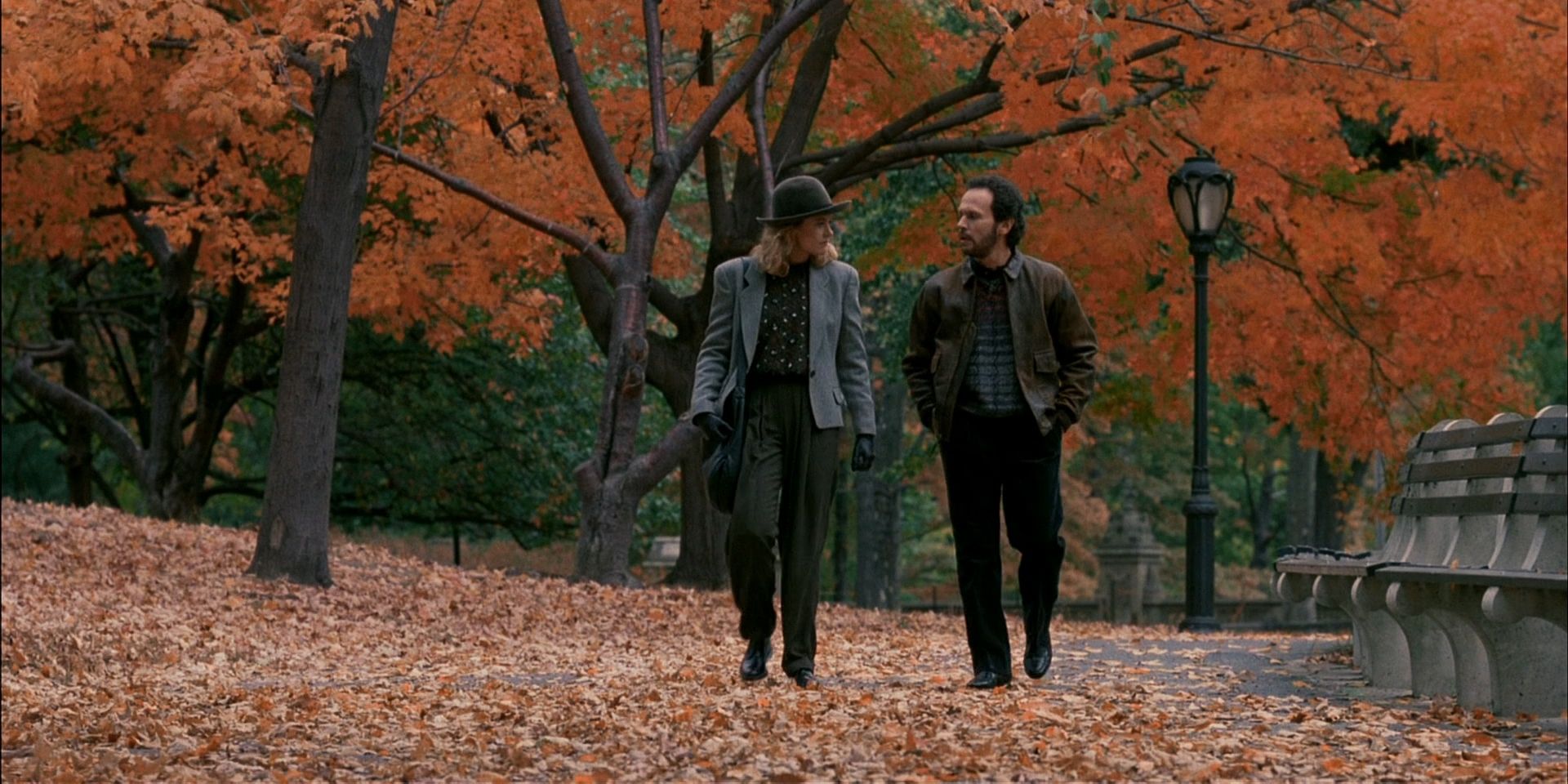 Sally, played by Meg Ryan, and Harry, played by Billy Crystal, walk together in a park in When Harry Met Sally