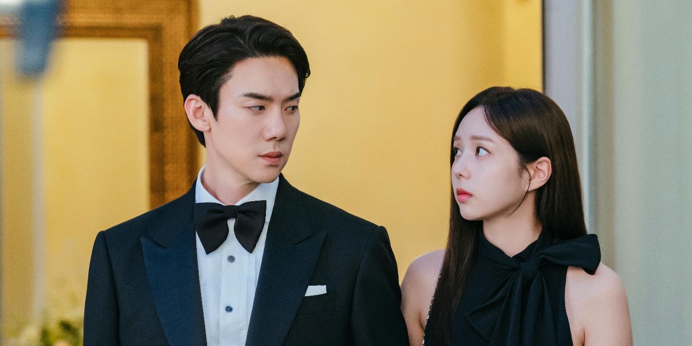 Hee-joo (Chae Soo-bin) and Sa-eon (Yoo Yeon-seok) in black formalwear looking at each other in When the Phone Rings