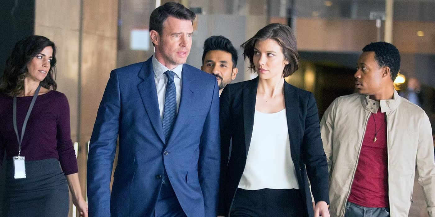 The cast of 'Whiskey Cavalier' walking down a hallway in suits.