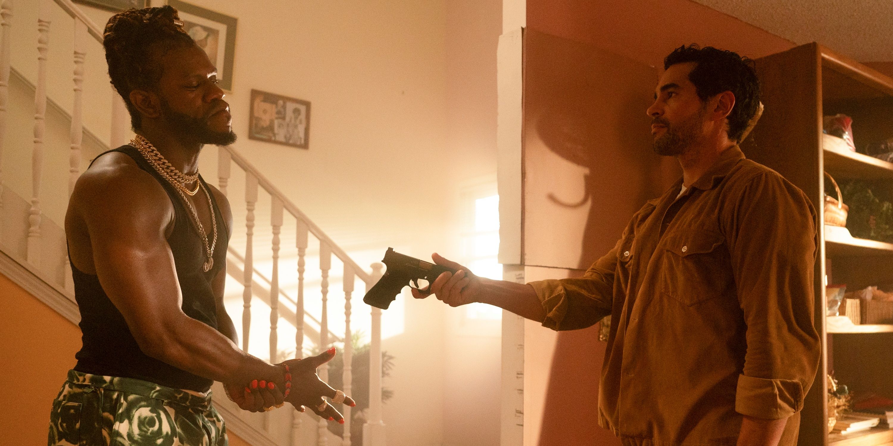 Ramon Rodriguez as Will Trent handing a gun back to Antwayn Hopper as Rafael Wexford in ABC&rsquo;s Will Trent
