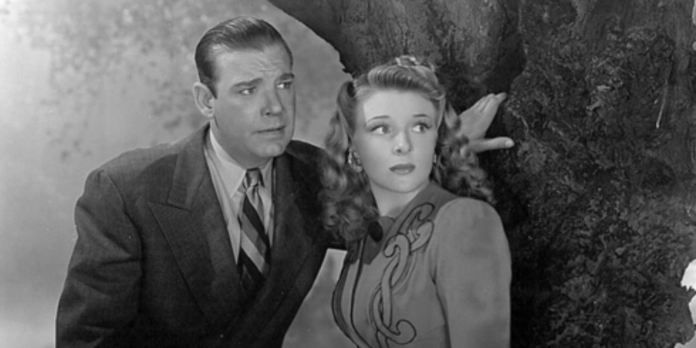 Lon Chaney Jr as Larry Talbot leaning against a tree next to Evelyn Ankers as Gwen in 1941&rsquo;s The Wolf Man
