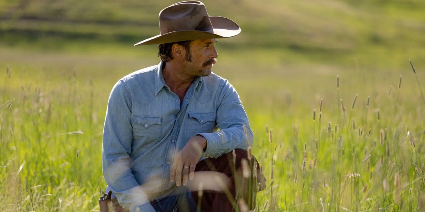 Young John Dutton (Josh Lucas) sits in a field on 'Yellowstone'