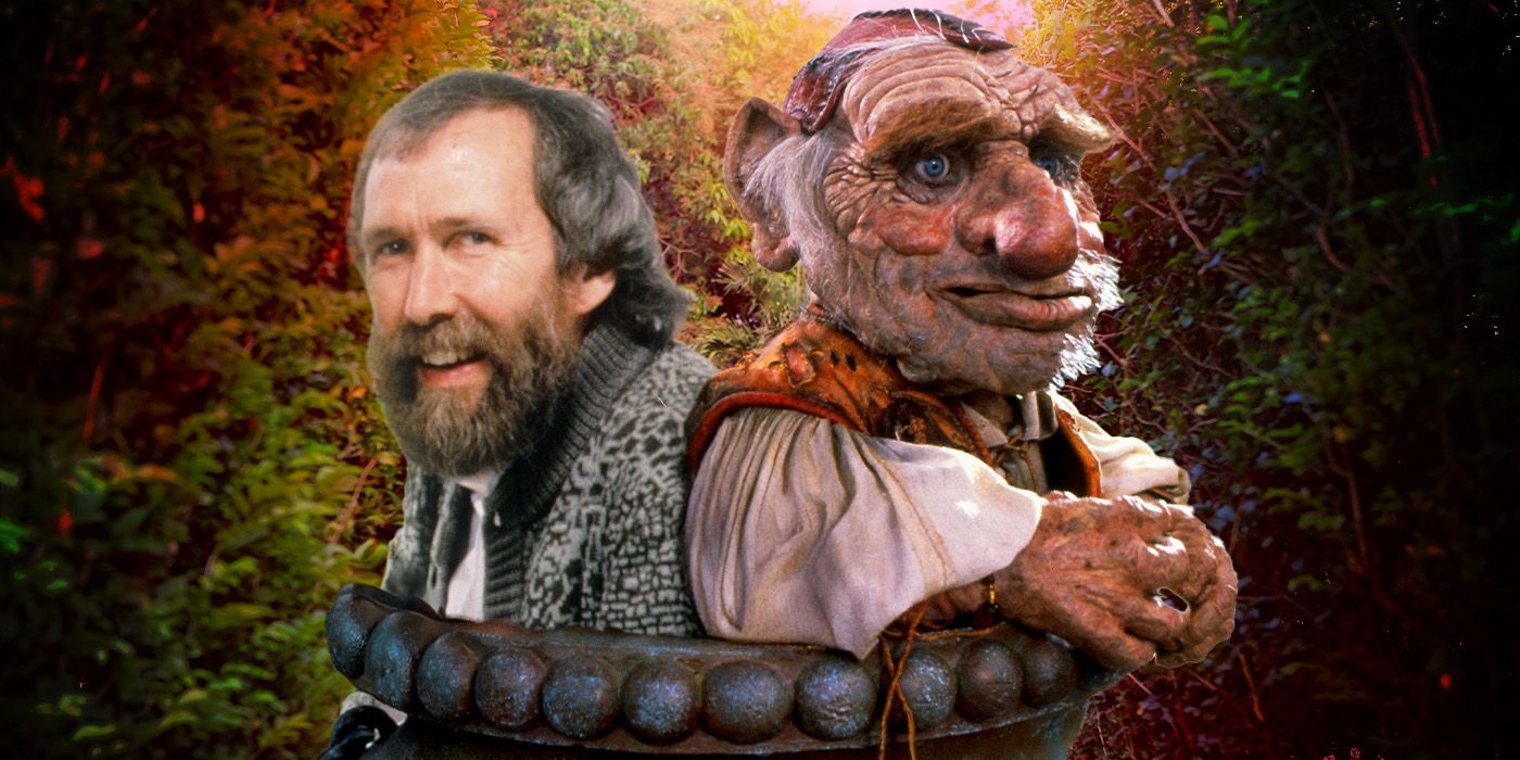 Jim Henson and the character Hoggle from Labyrinth emerge from a large stone pot in front of a leafy background.