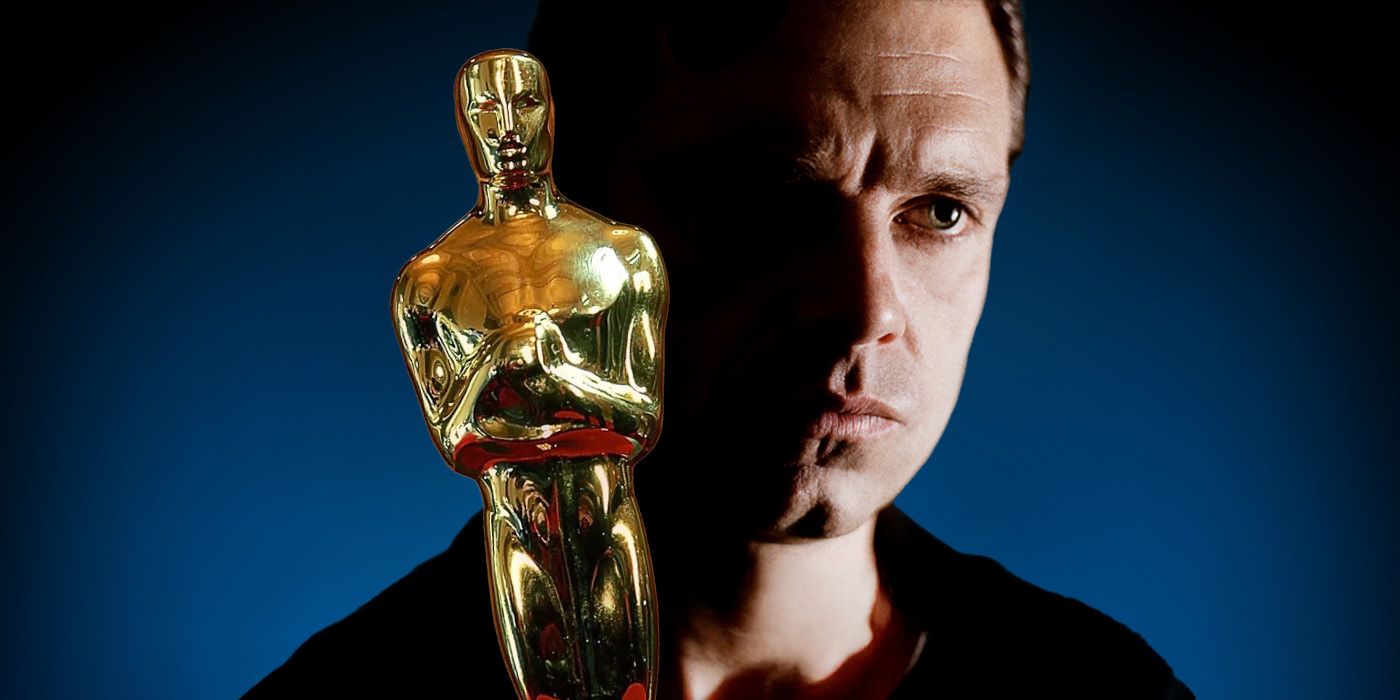 Actor Sebastian Stan stands in the shadows behind an Academy Award.