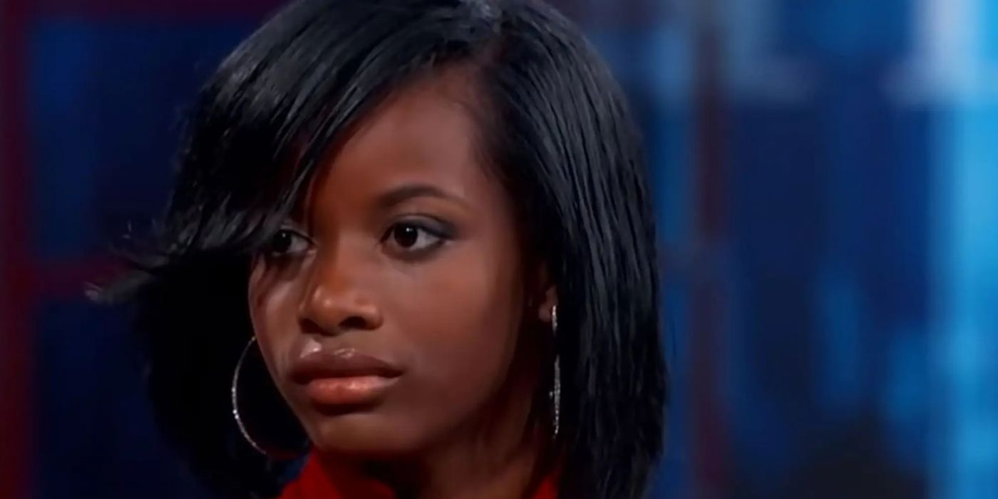 Treasure, a young woman, looks despondent, sitting on the stage of the Dr. Phil TV show.