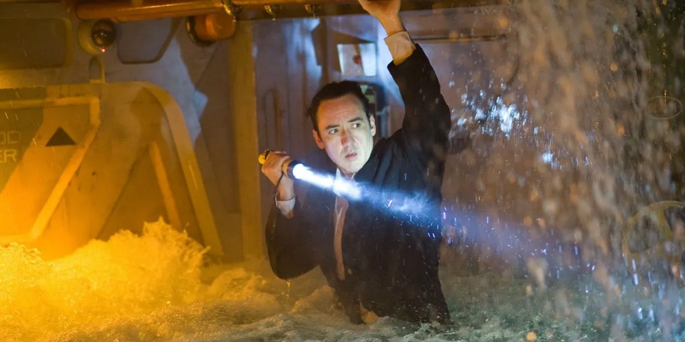 Jackson Davis (John Cusack) shines a flashlight in a flooded corridor in &lsquo;2012&rsquo;