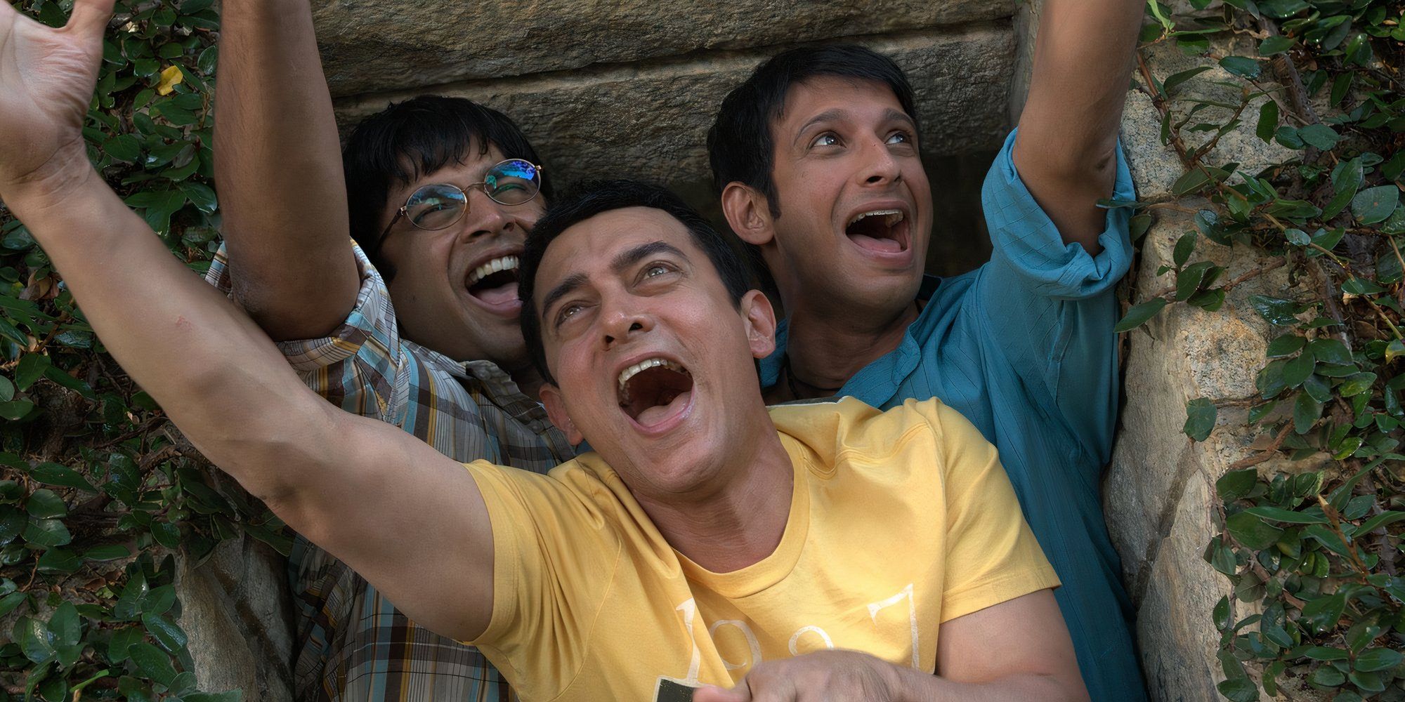 the three main characters are sitting happily from 3 idiots.