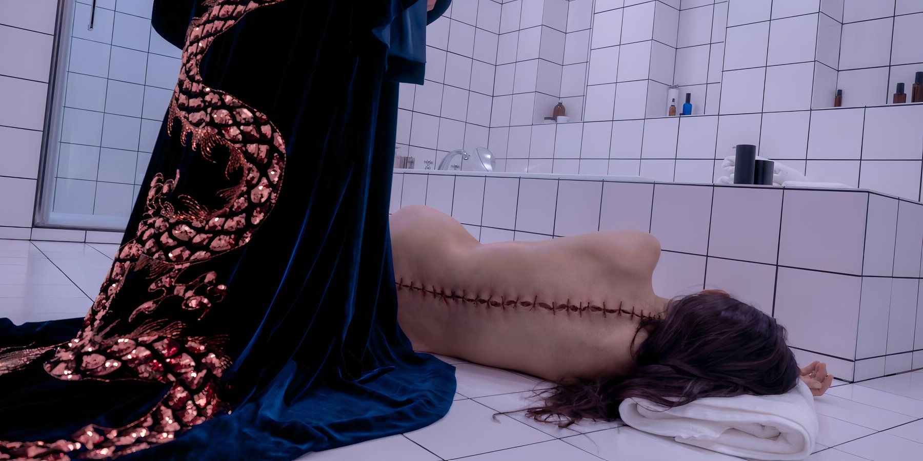 Someone looks down on the stitched-up body of Demi Moore in The Substance