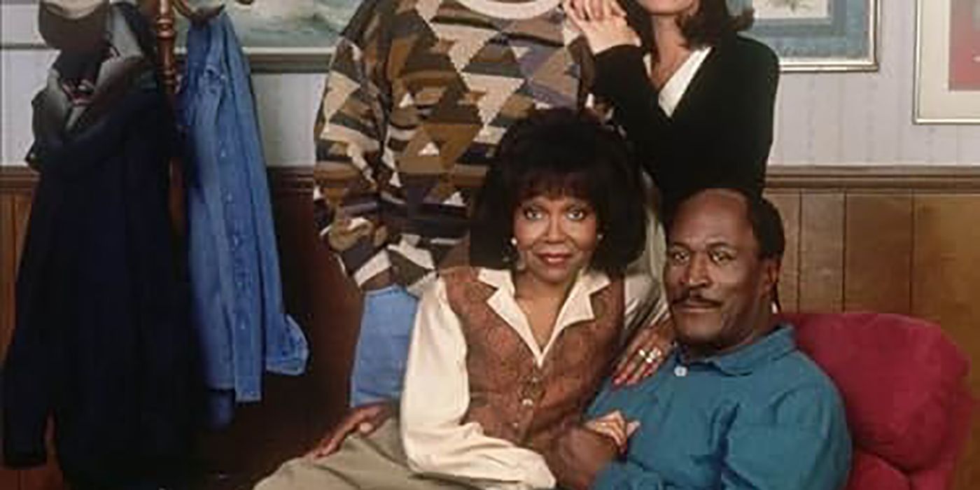 A man sitting in a recliner chair, a woman sitting on his lap in 704 Hauser.